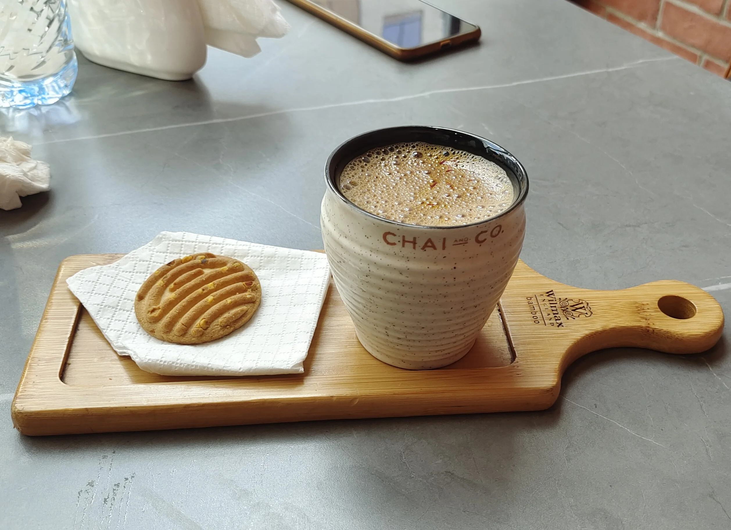 Chai latte photographed on busy cafe prep station