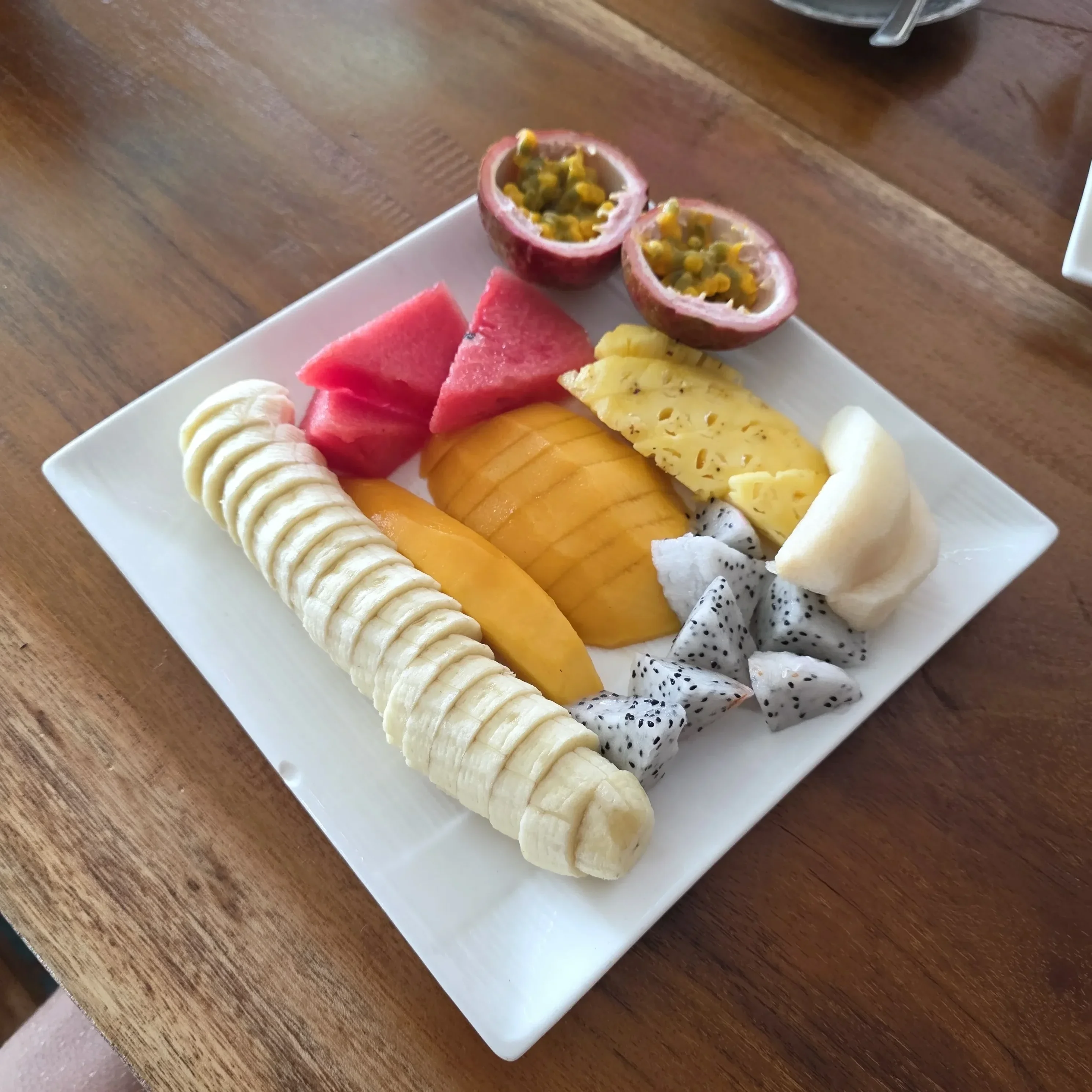 Fresh fruit salad bowl photographed in busy cafe kitchen
