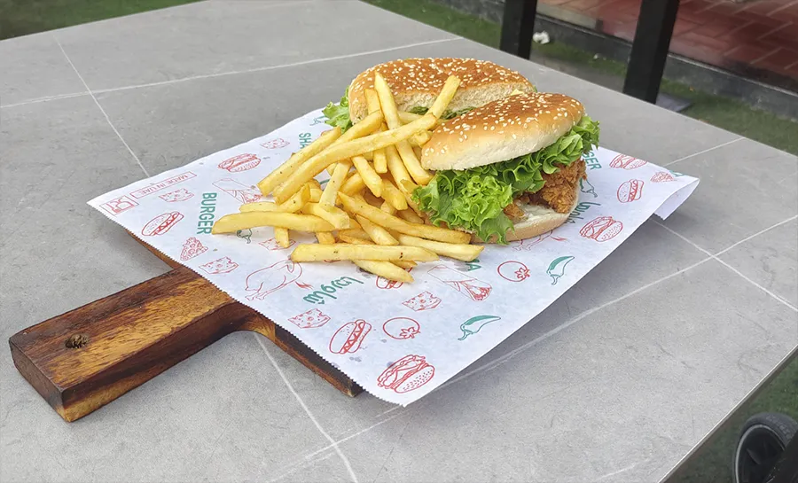Burger phone snapshot with flat lighting and cluttered background